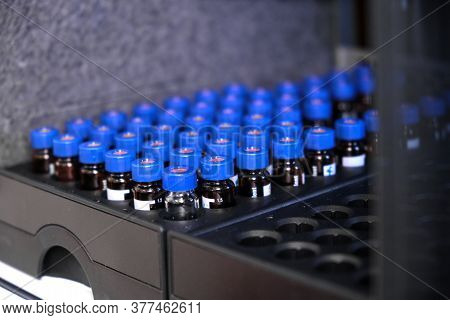 Glass Vials With Blue Caps Are In The Rack Of Hplc System With Autosampler. Separation Of Compounds 