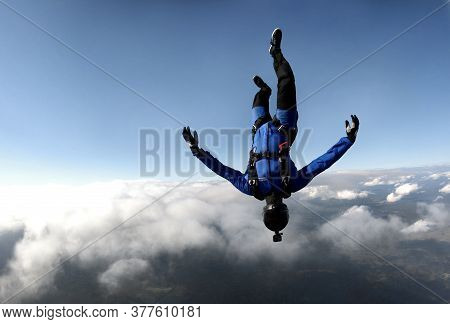 Freefly Skydiving. A Young Man Is Flying In The Sky In Headdown Position