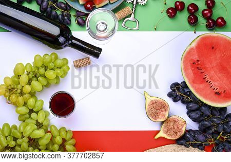 A Bottle Of Wine, Wineglass, Grapes, Different Fruits And The Flag Of Italy. Country Symbol Backdrop