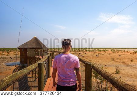 Tosha National Park, Namibia - April 2, 2019 : Tourist Walks Towards A Wildlife Hide Located At The 