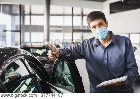 Asian Saleman Wear Surgical Mask Working In Inspector Checking Writing On Clipboard In Garage Of Dea
