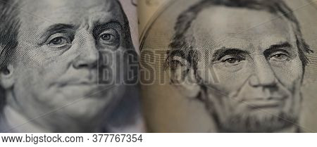 One Hundred Dollars And Five Dollar Bills. Closeup Of Benjamin Franklin And Abraham Lincoln . Us Dol