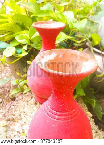 A Top Angle View Of Two Earthen Pots Placed In A Garden.the Pots Have Big Mouth And A Narrow Neck.th