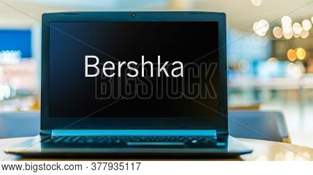 Laptop Computer Displaying Logo Of Bershka