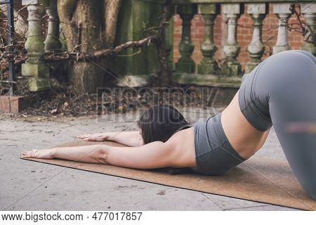 Close-up Of An Irish Female Yoga Teacher In An Extended Puppy Pose (uttana Shishosana) On A Cork Mat
