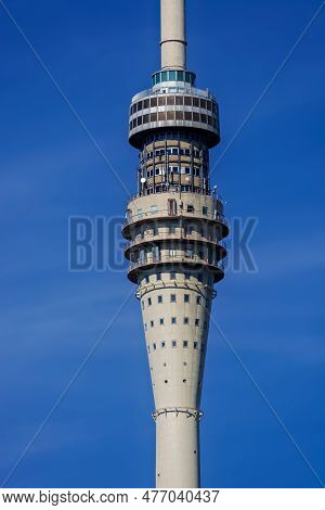 Fragment Of A Television Tower With A Television Center Against The Blue Sky Near The Center Of Dres