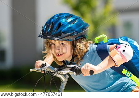Little Kid Boy Ride A Bicycle In The Park. Kid Cycling On Bicycle. Happy Smiling Child In Helmet Rid