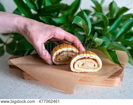 Person Taking One Of Two Buns, Selective Focus. Freshly Baked Sweet Rolls Called Kyata