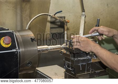 The Machine Operator Working With Lathe Machine. The Metalworking Process By Turning Machine.