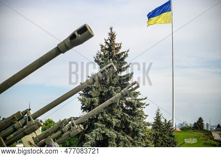 Groups Of Ancient Military Guns Against The Background Of The State Flag Of Ukraine. Muzzle Brake Of