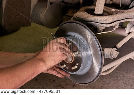 Replacing Brake Rotor Disc On A Car In The Service Garage