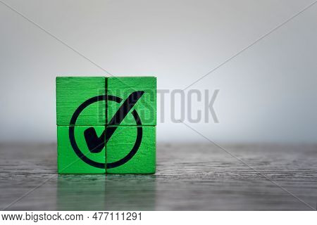Green Wooden Cubes With Checkmark Icon. Corporate Regulatory Compliance, Achievement, Completed Task