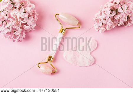 Pink Jade Roller And Gua Sha For Face Massage With Flowers Daffodils And Lilacs. Facial Massager Too