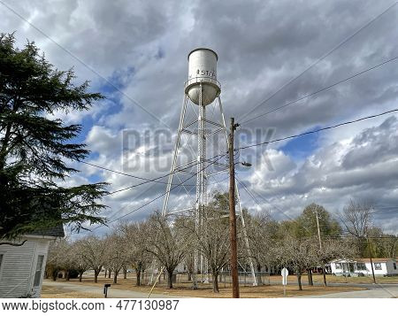 Stapleton, Ga Usa - 01 25 21: Distant White Old Vintage Retro Water Tower And Cloudy Sky In The Fall