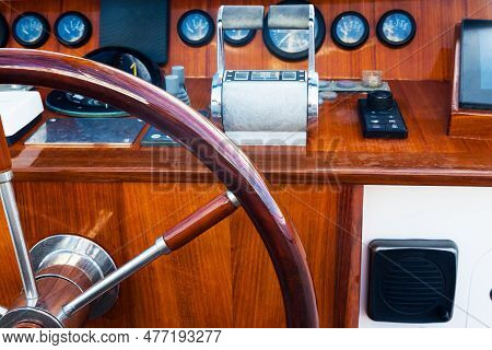 Motor Yacht Control Panel. Steering Wheel, Gear Levers, Gauges, Speedometers And Control Buttons.