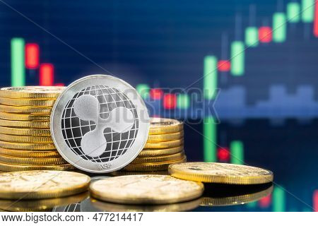 Ripple Xrp And Cryptocurrency Investing Concept - Physical Metal Ripple Coins With Global Trading Ex