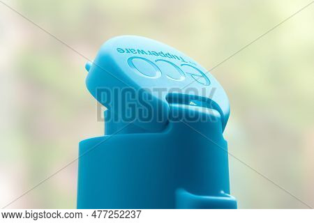Tupperware Lids With Logo. Tupperware Brand Plastic Bottle Cap Close-up. Textured Image With Shallow
