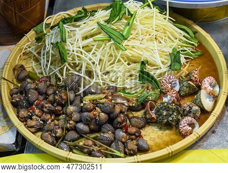 Vietnamese Stewed Seashells In Sauce In The Night Market On Food Festival