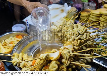 Hand Adding Water In Bouillion For Korean Fish Cakes