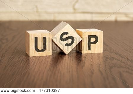 Unique Selling Proposition Concept With Symbols Usp On Wooden Cubes, Dark Wooden Background