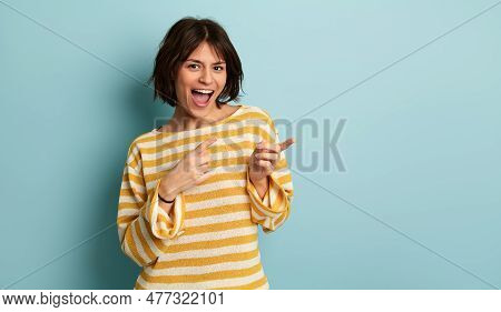 Cheerful Young Hispanic Female Model With Dark Hair In Yellow And White Striped Blouse, Shouting Hap
