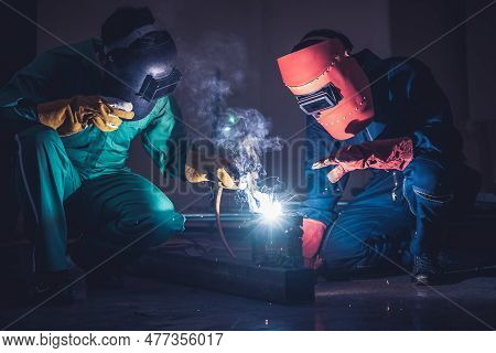 Metal Welding Steel Works Using Electric Arc Welding Machine To Weld Steel At Factory. Metalwork Man