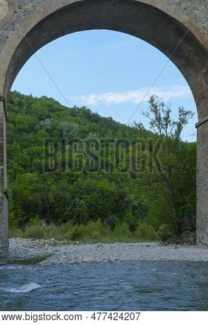 Under The Arch Of Old Bridge Over The River Enza In Neviano Degli Arduini, Parma, Emilia Romagna, It