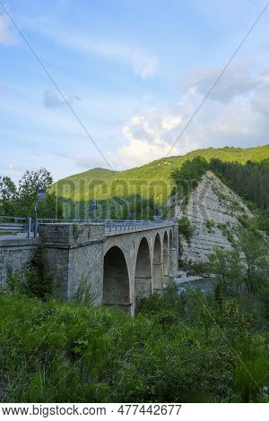 Old Bridge Over The River Enza In Neviano Degli Arduini, Parma, Emilia Romagna, Italy During The Sun