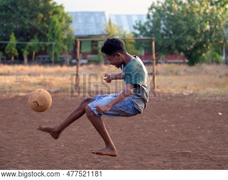 Maumere, Flores, Indonesia- May 23, 2023: Some Boys Are Playing Soccer In The Field.