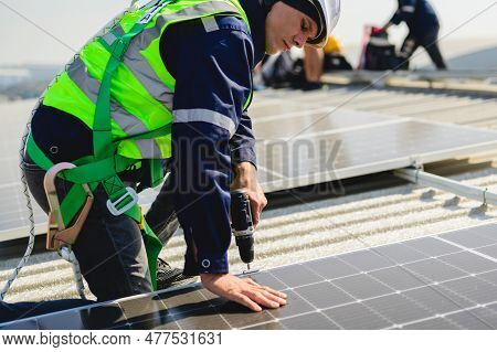 Engineers With Safety Helmet Checking Solar System At Solar Power Farm