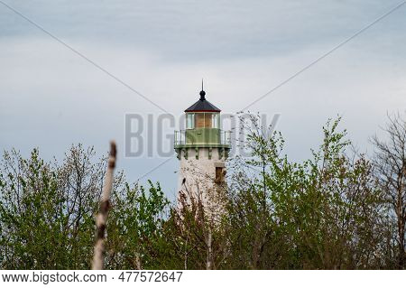 The Tawas Point Lighthouse Fresno Lens Under Repair As It Towers Over The Wilderness