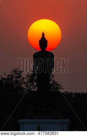 Head Of Statue Of Buddha Image Surrounded By Sun During Sunset At Budda Monthon In Nakhon Pathom, Th