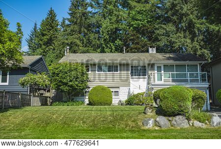 Beautiful Exterior House In Rural Suburban Neighborhood. Real Estate Exterior Front House On A Sunny