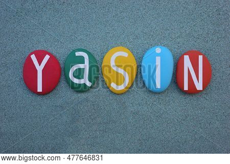 Yasin, Turkish Masculine Given Name Composed With Multi Colored Stone Letters Over Green Sand