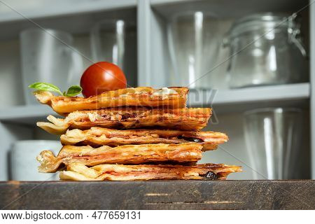 Homemade Pizza Waffle With Tomato Sauce, Pepperoni, Olives And Parmesan Cheese On A Cutting Board On