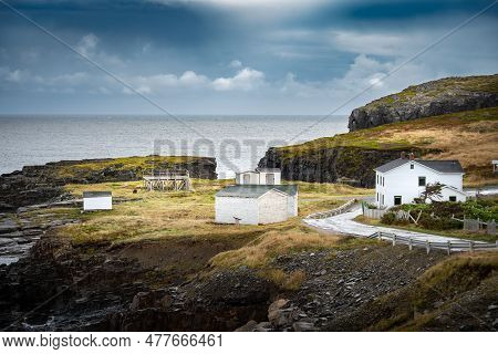 East Coast Homes And Buildings With Atlantic Cod Drying Racks On A Grassy High Rock Peninsula Near E
