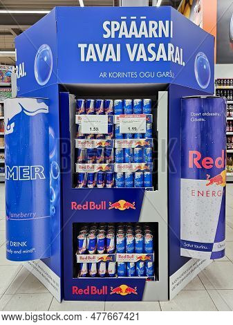 Latvia, Riga, May, 2023: Bright Advertising Stand With Aluminium Cans Of Red Bull Energy Drink. Red 