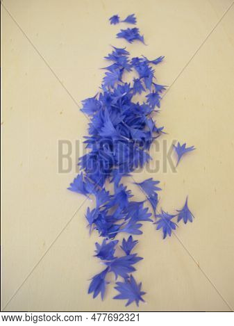 Edible Flower - Blue Cornflowers Petals On A Wooden Board