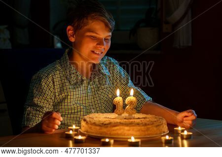 Happy Blond Little Kid Boy Celebrating His Birthday. Preteen Child Blowing Candles On Homemade Baked