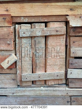 The Traditional Free-range Chicken Dwelling Is Made Of Brown Wood, The Cage Is At The Back Of The Ho