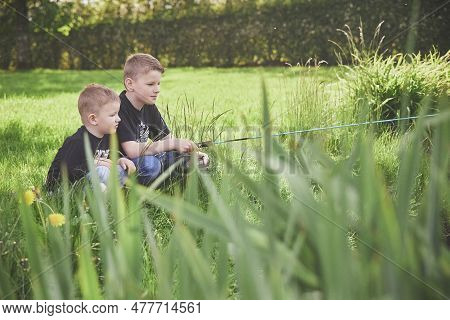 Skjern, Denmark, May, 2023: Two Brothers Are Fishing In The Lake