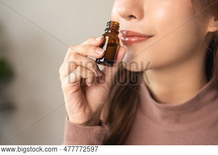 Aromatherapy, Attractive Asian Young Woman Hand Holding Bottle Of Essential Perfume Oil, Enjoying Sm