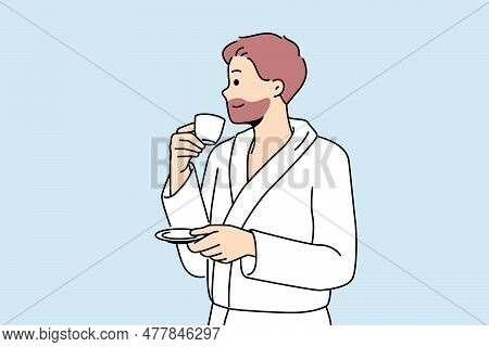 Man In Bathrobe Drinks Coffee Enjoying Hot Tart Drink After Waking Up In Morning. Successful Young M