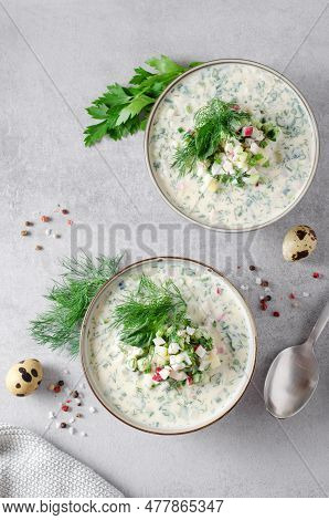Cold Okroshka Soup With Eggs, Vegetables, Meat, Herbs And Kefir On A Bright Background, Summer Soup