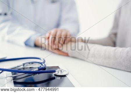 Stethoscope Lying On The Tablet Computer In Front Of A Doctor And Patient At The Background . Medici
