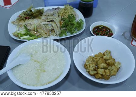 Chinese Style Porridge Or Congee Served With Hainan Boiled Chicken And Herbs. Sold In Jakarta, Indon