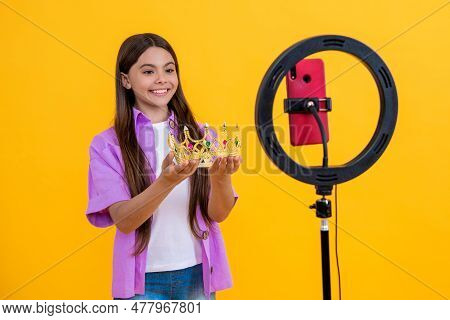 Glad Teen Girl Influencer With Crown Isolated On Yellow. Teen Girl Influencer With Crown In Studio. 