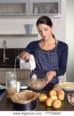 Young Woman Baking An Apple Pie In The Kitchen