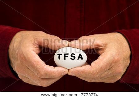 Man Holds White Nest Egg With TFSA Written On It