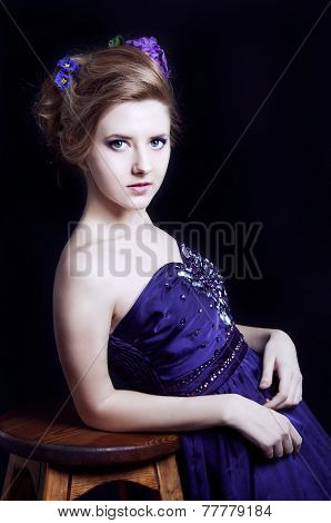 Elegant Young Blonde Woman In A Violet Dress